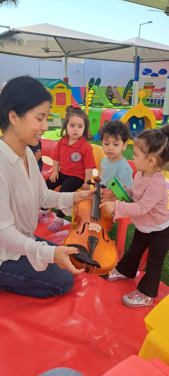 Toddlers exploring musical instruments – early childhood music classes in St. Catharines and Niagara Region